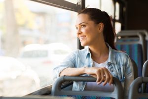 beautiful young woman taking bus to work